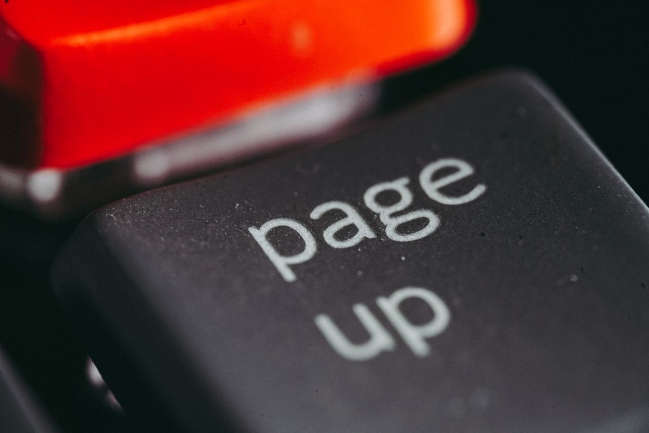 Services Close-up macro photography of a keyboard's 'page up' key, highlighting its texture and design.