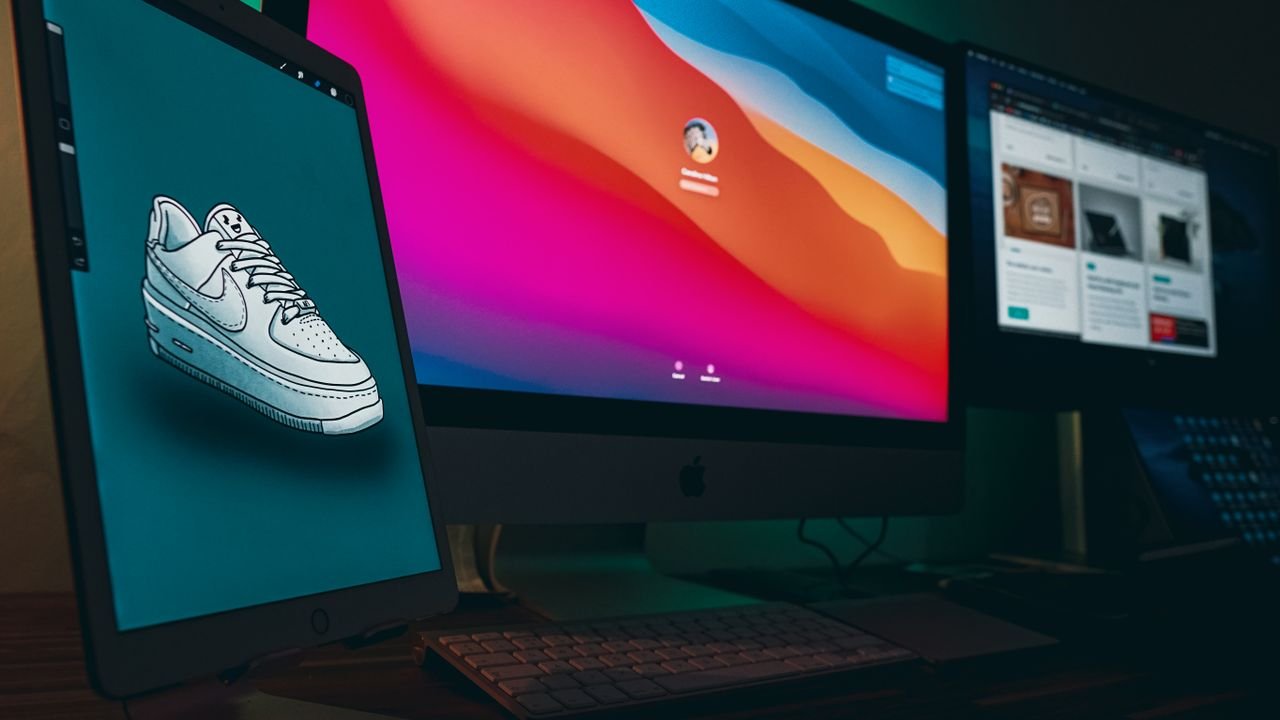 Home A digital workspace featuring Apple devices with Nike sneaker design displayed on a tablet.